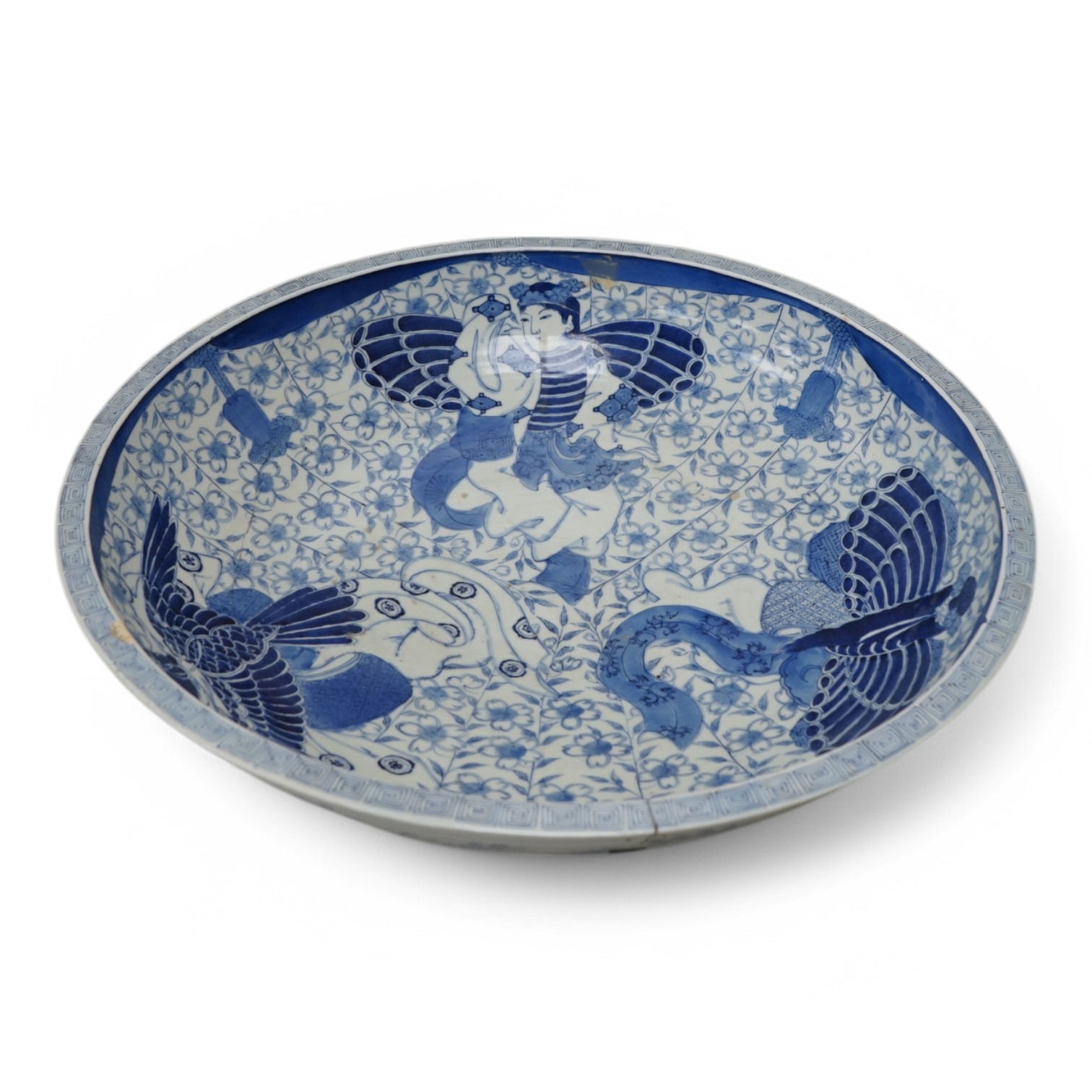 A large Japanese blue and white decorated charger, 47cm diameter. Condition - riveted and chips to rim